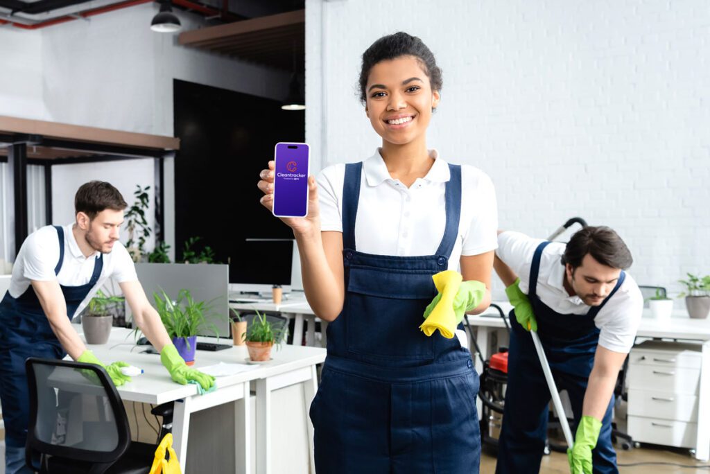 Cleaner confidently displaying the Cleantracker app on a device, demonstrating the user-friendly interface for streamlined cleaning management and reporting.